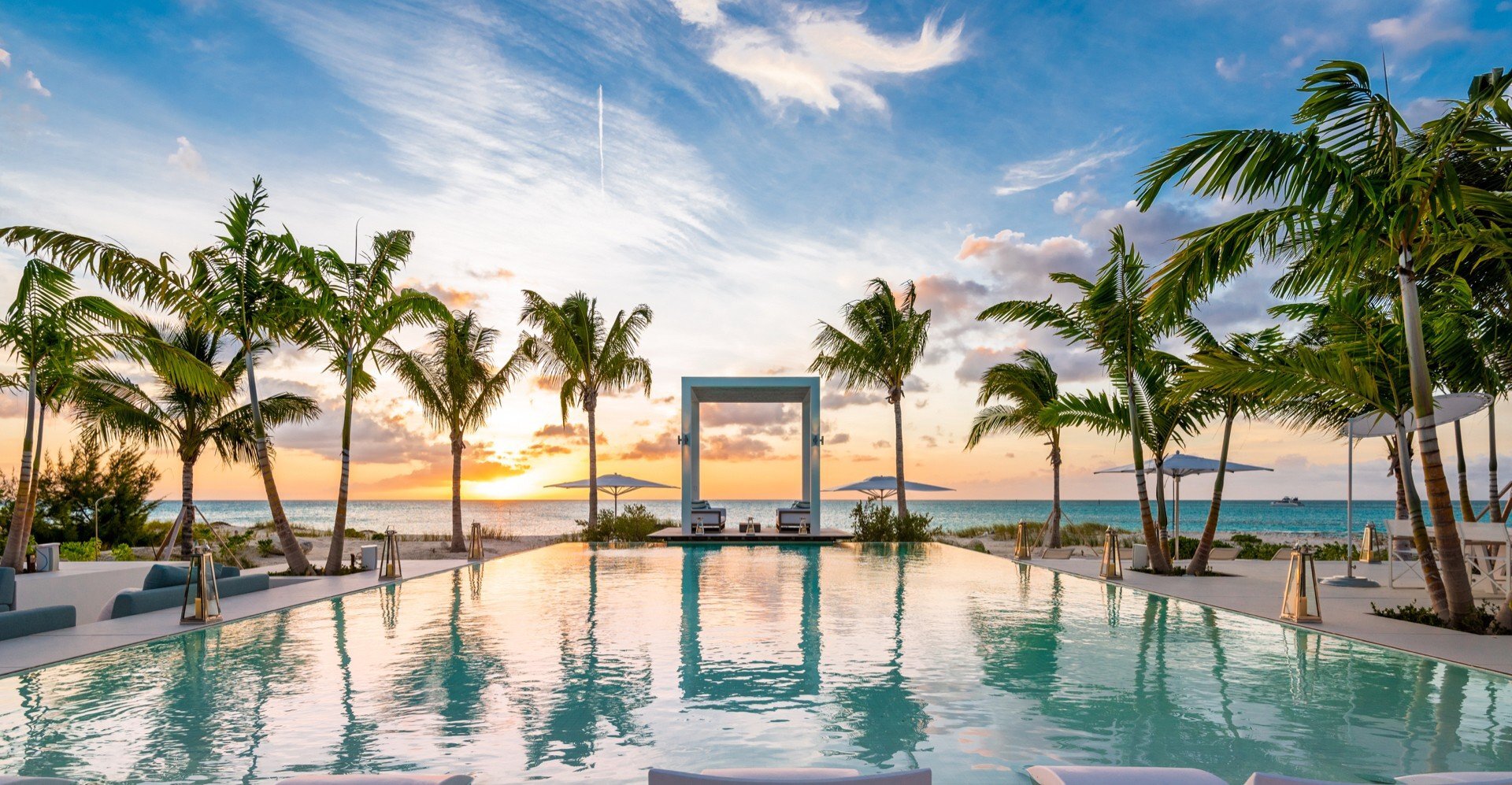 Infinity pool at sunset at Emerald Pavilion, a luxury villa in Turks and Caicos offered by Isle Blue
